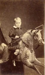 Niño con látigo en caballo de balancín, 1870s
